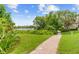 Lush backyard with a brick path leading to the lake at 762 Onyx Pkwy, Deland, FL 32724