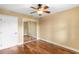 Bedroom with hardwood floors, closet with mirrored doors, and a ceiling fan at 762 Onyx Pkwy, Deland, FL 32724