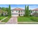 Beautiful two-story home with a red tile roof, balconies, a brick driveway, and manicured landscaping at 762 Onyx Pkwy, Deland, FL 32724