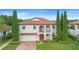 Two-story home with a tile roof, arched entry, and manicured landscaping at 762 Onyx Pkwy, Deland, FL 32724