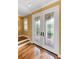 Interior view of the foyer with decorative glass doors, hardwood flooring, and staircase at 762 Onyx Pkwy, Deland, FL 32724