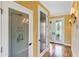Hallway view with Wine Cellar, hardwood flooring, and decorative glass front entry doors at 762 Onyx Pkwy, Deland, FL 32724