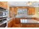 Open kitchen featuring wood cabinets, granite countertops, stainless appliances, and hardwood floors at 762 Onyx Pkwy, Deland, FL 32724