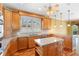 Well-lit kitchen with wood cabinets, stainless appliances, granite counters, and center island at 762 Onyx Pkwy, Deland, FL 32724
