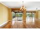 Spacious living room with hardwood flooring, recessed lighting, and access to balcony overlooking lake at 762 Onyx Pkwy, Deland, FL 32724