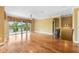 Spacious living room featuring hardwood floors and sliding glass doors to a large balcony overlooking water at 762 Onyx Pkwy, Deland, FL 32724