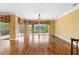 Bright living room with hardwood floors and sliding glass doors to a large balcony with water views at 762 Onyx Pkwy, Deland, FL 32724