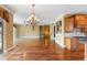 Large open-concept living room and kitchen features hardwood floors and water view balcony at 762 Onyx Pkwy, Deland, FL 32724
