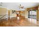 Open-concept living room featuring hardwood floors with kitchen and water view balcony at 762 Onyx Pkwy, Deland, FL 32724