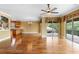 Open-concept living room with hardwood floors and sliding glass doors leading to balcony, flowing into the kitchen at 762 Onyx Pkwy, Deland, FL 32724