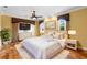 Spacious main bedroom with hardwood floors, ceiling fan, and views of the outdoors at 762 Onyx Pkwy, Deland, FL 32724