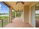 Inviting covered patio with brick flooring, offering a scenic view of the lake and surrounding landscape, perfect for relaxation at 762 Onyx Pkwy, Deland, FL 32724