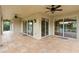 Expansive covered patio with tiled flooring, ceiling fans, and sliding glass doors offering picturesque outdoor views at 762 Onyx Pkwy, Deland, FL 32724