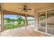 Serene covered patio showcasing a tranquil lake view surrounded by lush greenery and a clear blue sky at 762 Onyx Pkwy, Deland, FL 32724
