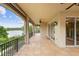 Scenic covered patio overlooking a tranquil lake, framed by black railings and lush greenery, perfect for relaxation at 762 Onyx Pkwy, Deland, FL 32724