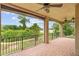 Picturesque covered patio featuring brick flooring, providing stunning views of the lake and lush gardens, an ideal retreat at 762 Onyx Pkwy, Deland, FL 32724