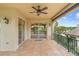 Charming covered patio with tiled floors, overlooking a serene lake view and beautiful landscaping, ideal for outdoor enjoyment at 762 Onyx Pkwy, Deland, FL 32724