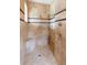 Luxurious tiled shower with a built-in seat, multiple shower heads, and elegant fixtures, offering a spa-like experience at 762 Onyx Pkwy, Deland, FL 32724