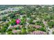 An aerial view shows this home in a lush, well-maintained neighborhood surrounded by trees at 8 Rising Moon Trl, Ormond Beach, FL 32174