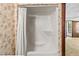 Bathroom with shower and leaf wallpaper and view into the bedroom at 8 Rising Moon Trl, Ormond Beach, FL 32174