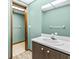 Bathroom with green walls, wood vanity and sink, and view into walk in closet area at 8 Rising Moon Trl, Ormond Beach, FL 32174