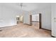 Bright bedroom with ceiling fan, railing overlooking living area, and en suite bathroom at 8 Rising Moon Trl, Ormond Beach, FL 32174