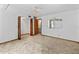 Bedroom with wall mirror, ceiling fan and wooden closet with shelving and access to bathroom at 8 Rising Moon Trl, Ormond Beach, FL 32174