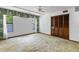 Bedroom featuring light carpet, natural light from windows, a ceiling fan, and closet with wood doors at 8 Rising Moon Trl, Ormond Beach, FL 32174