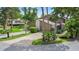 Aerial view of the house showcasing the driveway and tropical landscaping at 8 Rising Moon Trl, Ormond Beach, FL 32174