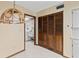 Hallway with tile floors, closet, and laundry room with washing machine and white cabinets at 8 Rising Moon Trl, Ormond Beach, FL 32174