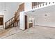 Spacious living room featuring a wooden staircase and partial view into the kitchen at 8 Rising Moon Trl, Ormond Beach, FL 32174