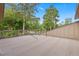 Private patio space featuring wood railing and surrounding trees at 8 Rising Moon Trl, Ormond Beach, FL 32174