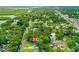 Aerial view of a home with surrounding greenery in a residential neighborhood at 812 Faulkner St, New Smyrna Beach, FL 32168