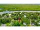 Scenic aerial view of property with trees and water views in a quiet neighborhood at 812 Faulkner St, New Smyrna Beach, FL 32168