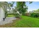 Paved patio and lush backyard with lawn, creating a serene outdoor space at 812 Faulkner St, New Smyrna Beach, FL 32168