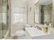 Well-lit bathroom with modern vanity, shower, and bathtub with glass door at 812 Faulkner St, New Smyrna Beach, FL 32168