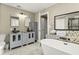 Elegant bathroom with double sinks, soaking tub, and mosaic tile accents at 812 Faulkner St, New Smyrna Beach, FL 32168