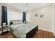 Comfortable bedroom with hardwood floors, large windows, and beach-themed decor at 812 Faulkner St, New Smyrna Beach, FL 32168