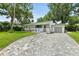 Charming home with well-manicured lawn and inviting front porch with chairs at 812 Faulkner St, New Smyrna Beach, FL 32168