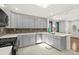 Bright kitchen featuring quartz countertops, tiled backsplash, and stainless steel appliances at 812 Faulkner St, New Smyrna Beach, FL 32168