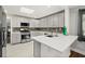 A modern kitchen with quartz countertops, stainless steel appliances, and ample storage at 812 Faulkner St, New Smyrna Beach, FL 32168