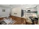 Open floorplan with hardwood floors connecting living room, dining area, and kitchen at 812 Faulkner St, New Smyrna Beach, FL 32168