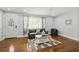 Cozy living room with hardwood floors, neutral decor, and a decorative front door at 812 Faulkner St, New Smyrna Beach, FL 32168