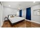 Stylish main bedroom with wood floors, recessed lighting, and blue curtains at 812 Faulkner St, New Smyrna Beach, FL 32168