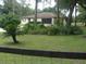 Charming single-story home with well-maintained lawn, mature trees, and welcoming curb appeal at 871 Oak Tree Ln, Lake Helen, FL 32744