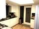 Cozy kitchen with white cabinets, green countertops, stainless steel trash can, and wooden floors at 871 Oak Tree Ln, Lake Helen, FL 32744