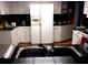 Bright kitchen featuring white appliances, light cabinets, and dark countertops at 871 Oak Tree Ln, Lake Helen, FL 32744