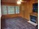 Living room showcasing tile floors, wood-paneled walls, and a built-in fireplace at 871 Oak Tree Ln, Lake Helen, FL 32744