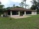Covered back patio offering a relaxing outdoor living space with a brick-paved area at 871 Oak Tree Ln, Lake Helen, FL 32744