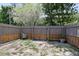 The backyard features a privacy fence with double-door gate and minimal greenery at 874 Commonwealth Ct, Casselberry, FL 32707